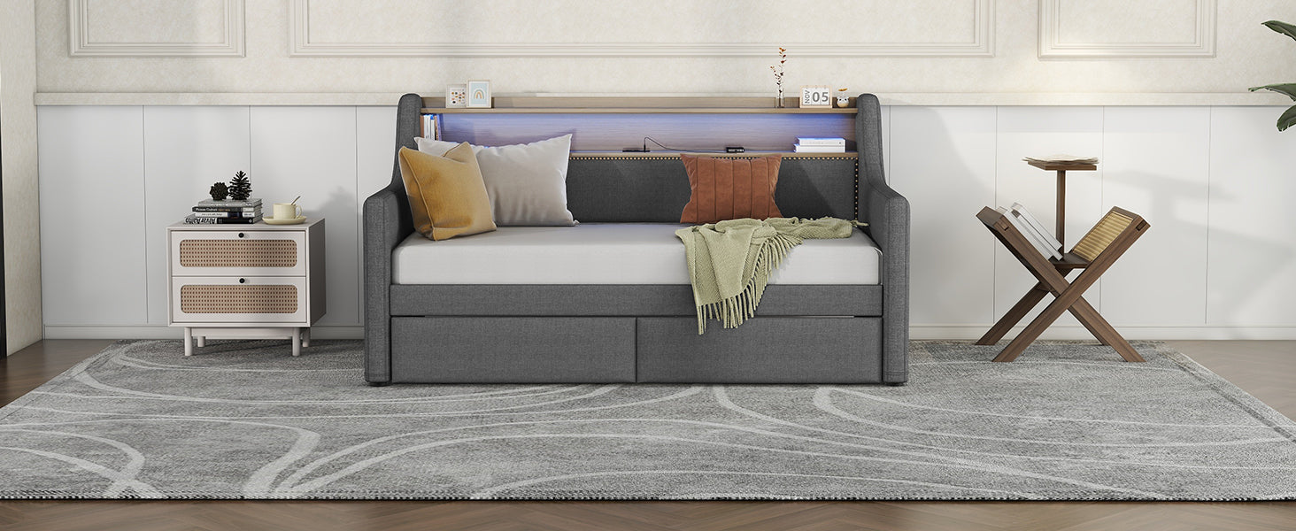 Dark grey upholstered daybed with integrated shelf and USB ports