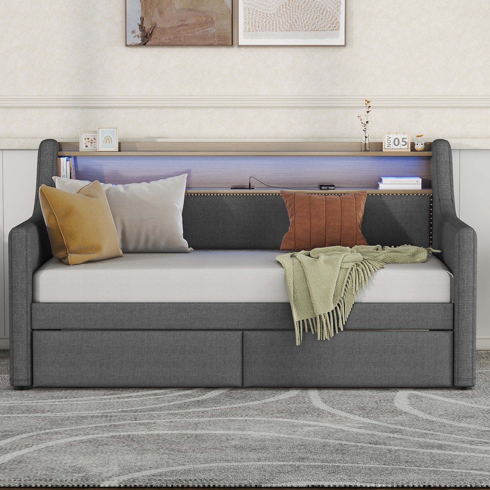 Dark gray upholstered daybed with builtin drawers and LED backlighting