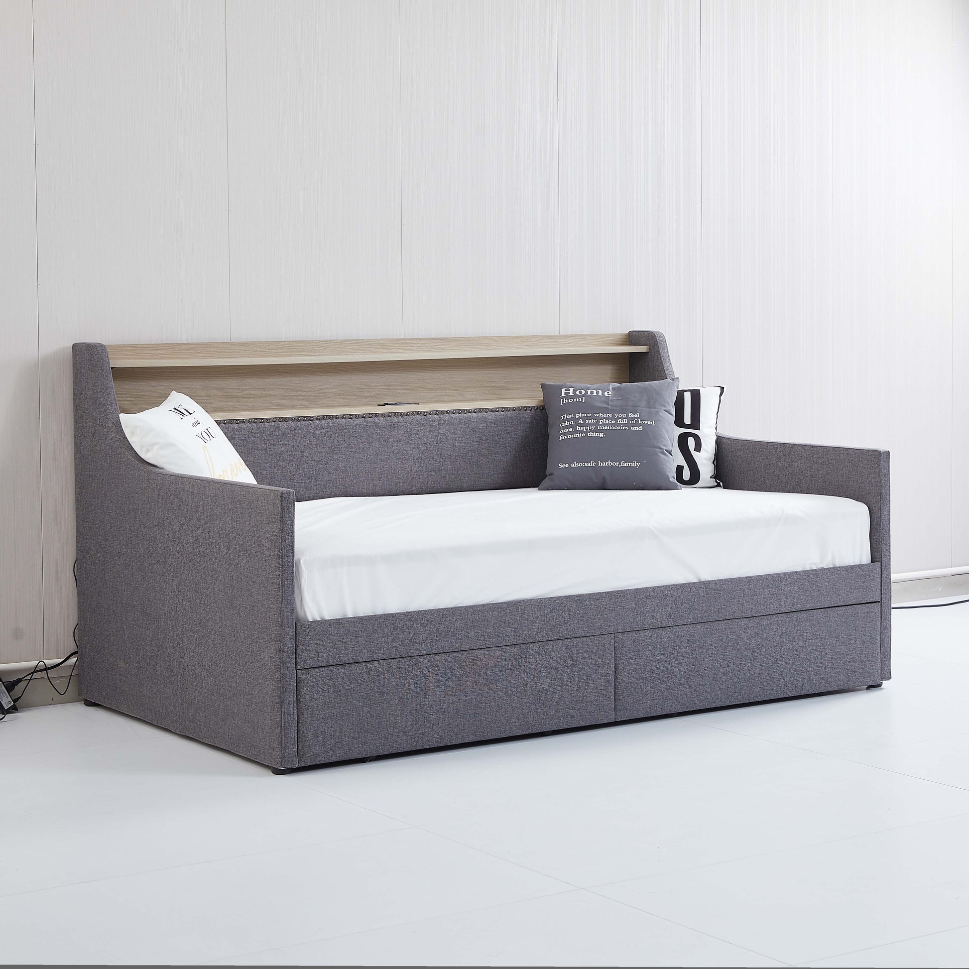 Grey fabric daybed with integrated shelf and two storage drawers