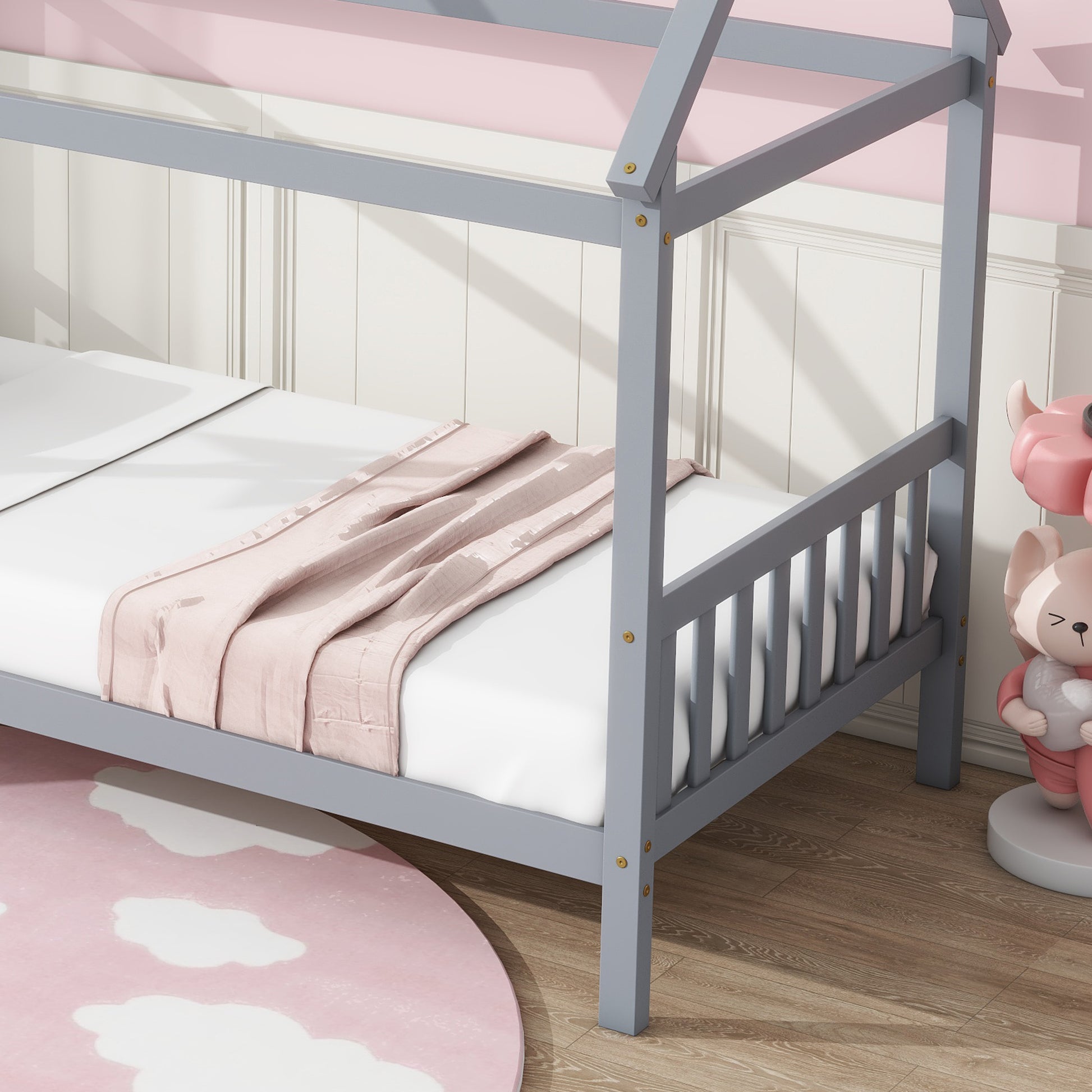 Gray wooden house bed frame with white mattress and pink throw blanket