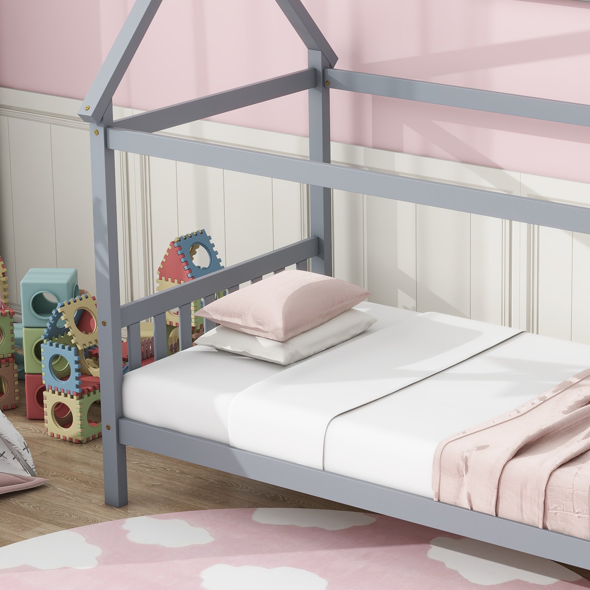 Gray wooden house bed frame with white bedding and pink blanket