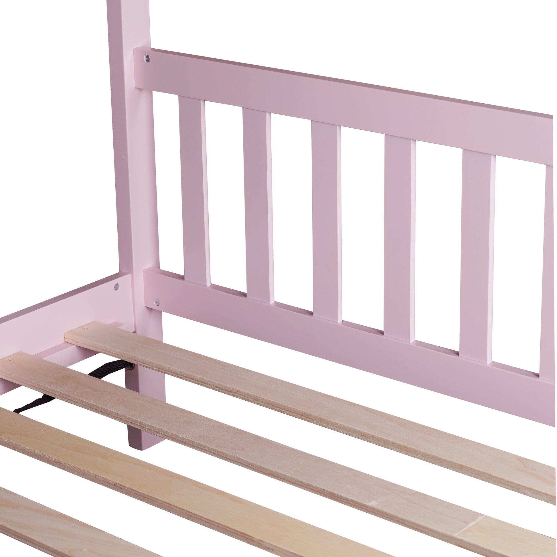 Closeup of pink wooden bed frame with natural wood slats