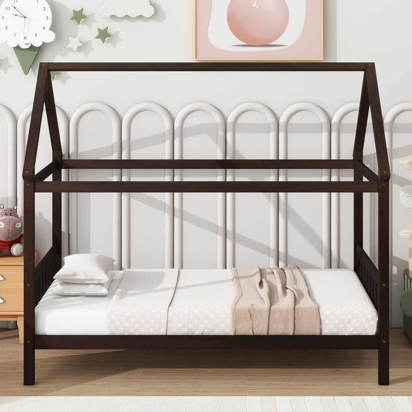 Dark brown wooden house bed frame with white bedding and tan throw blanket