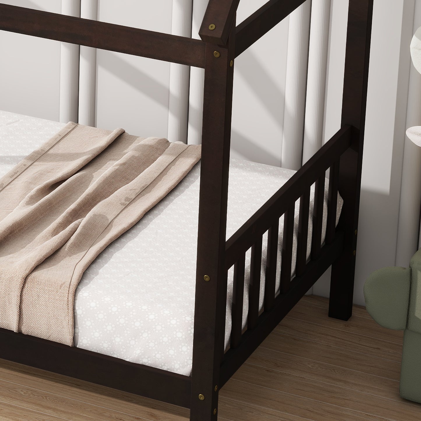 Dark wood toddler bed with white patterned sheet and beige blanket