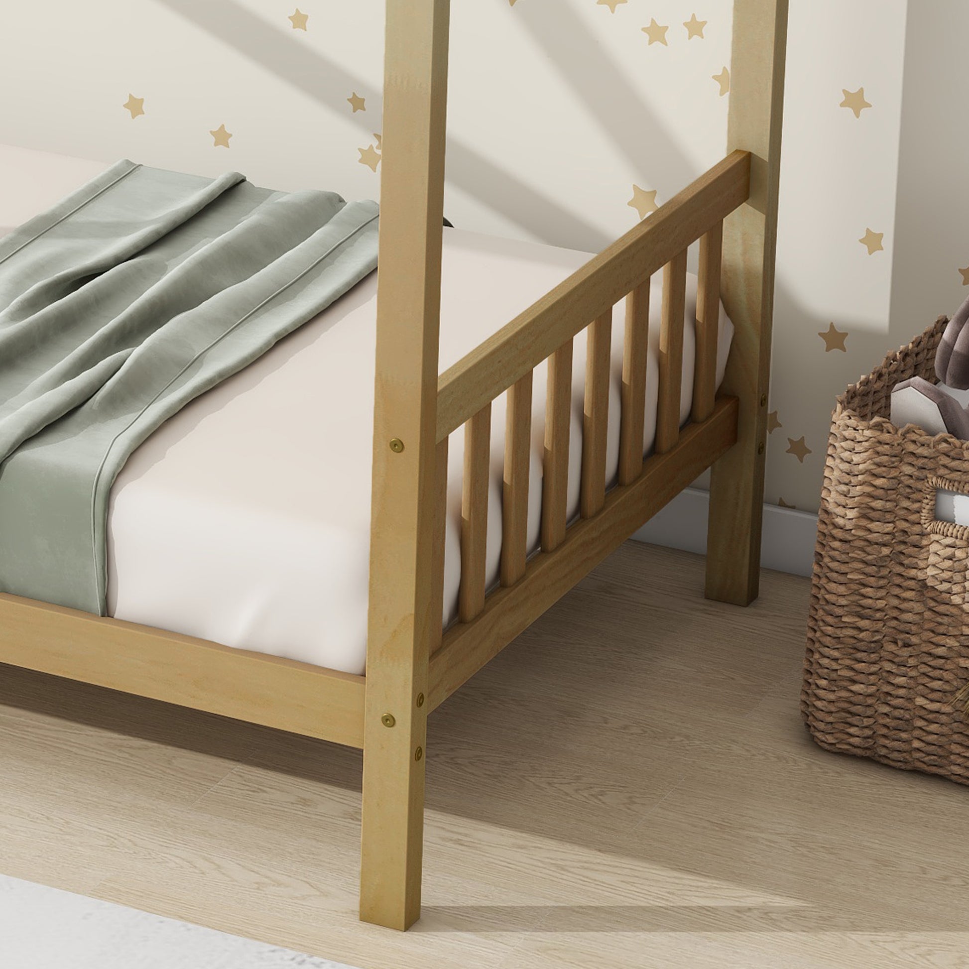 Natural wood toddler bed frame with white mattress and a light green blanket