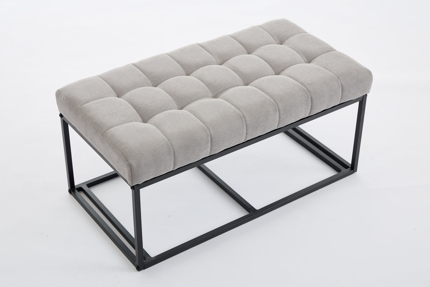 Tufted gray fabric bench with a minimalist black metal frame