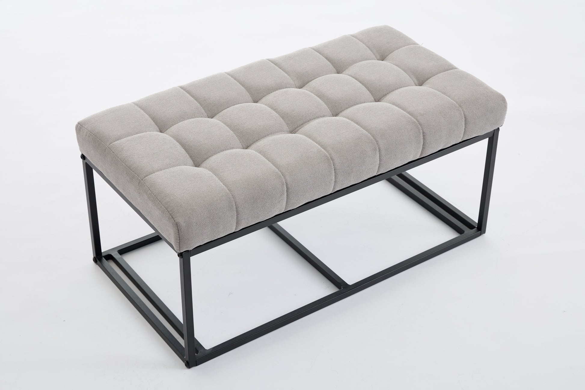 Tufted gray fabric bench with a minimalist black metal frame