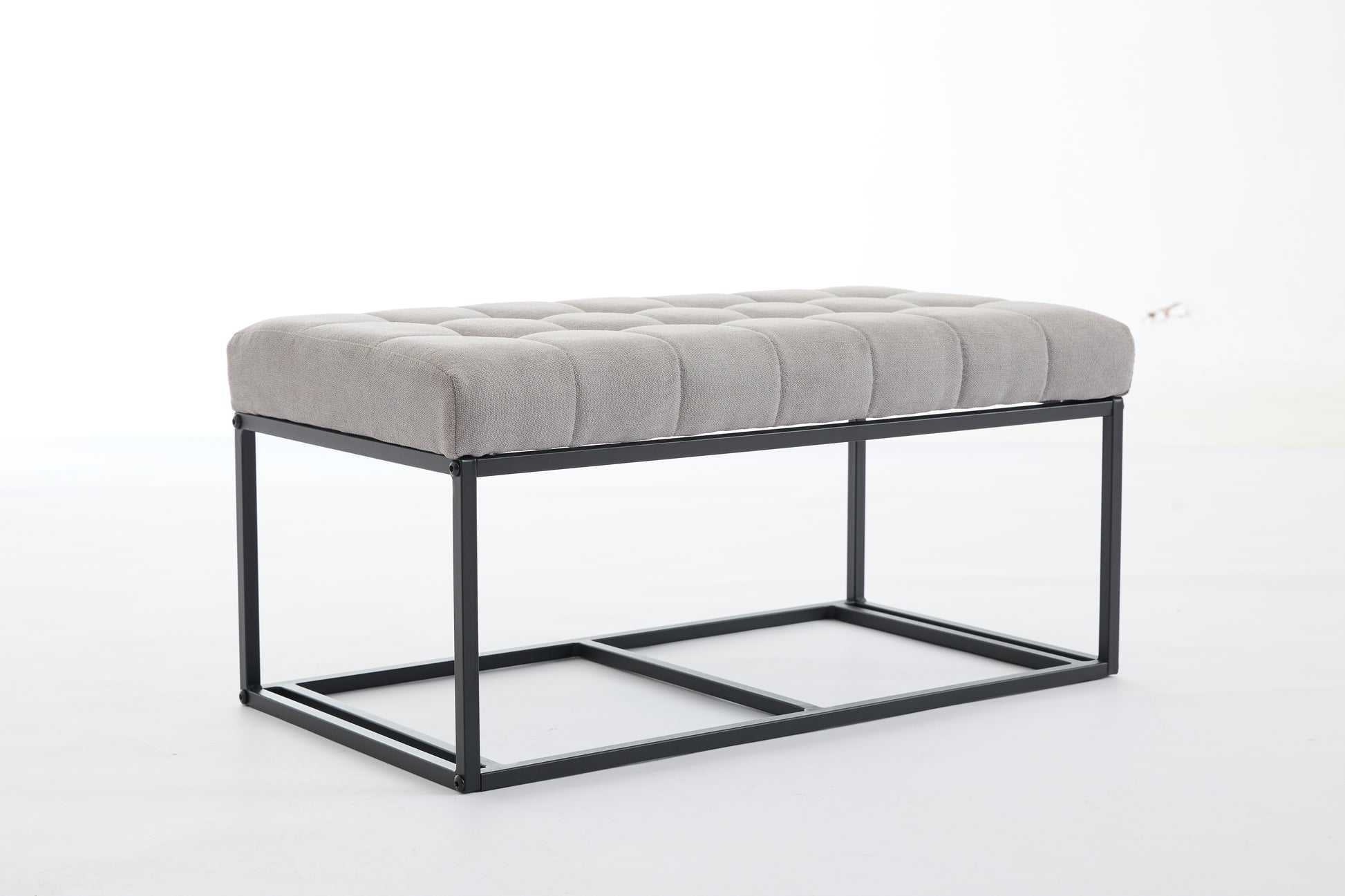 Tufted grey fabric bench with black metal frame