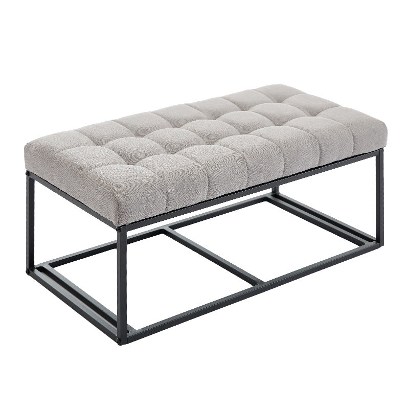 Tufted grey fabric bench with a black metal frame