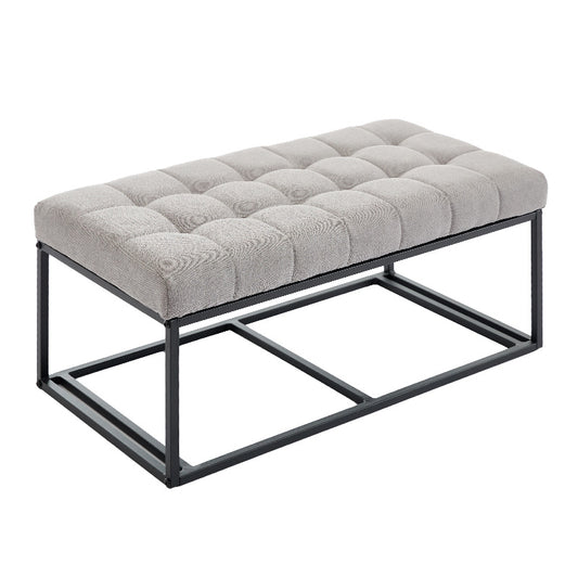 Tufted grey fabric bench with a black metal frame
