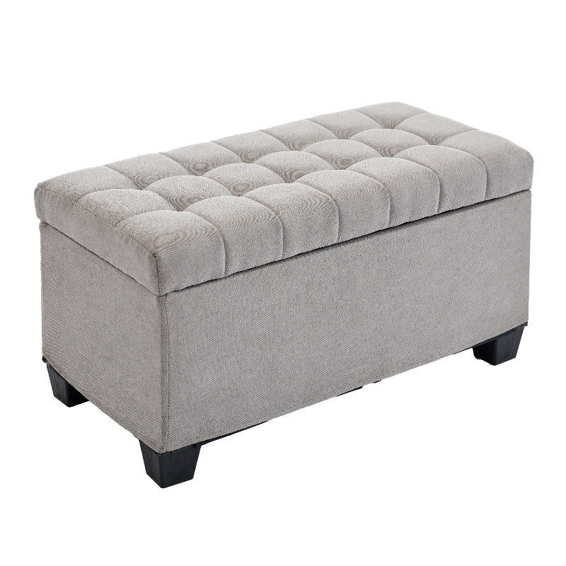 Grey tufted storage ottoman with dark wooden legs