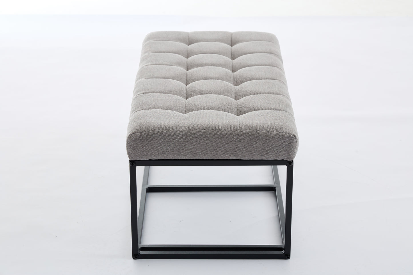 Gray tufted upholstered bench with black metal frame