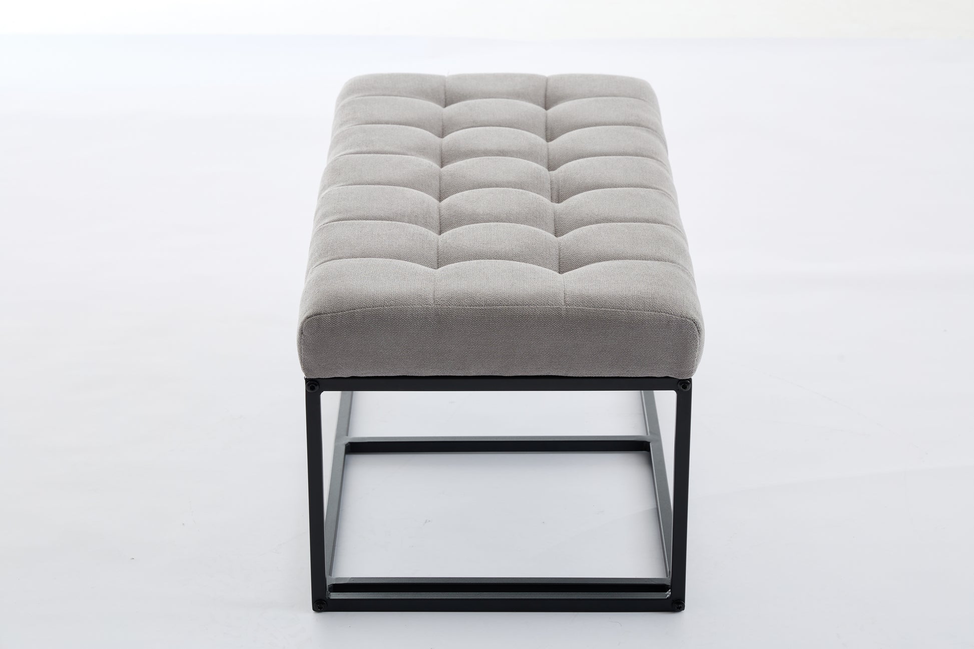 Gray tufted upholstered bench with black metal frame