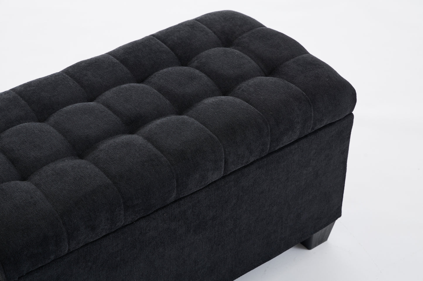 Black tufted storage ottoman with linenlike fabric