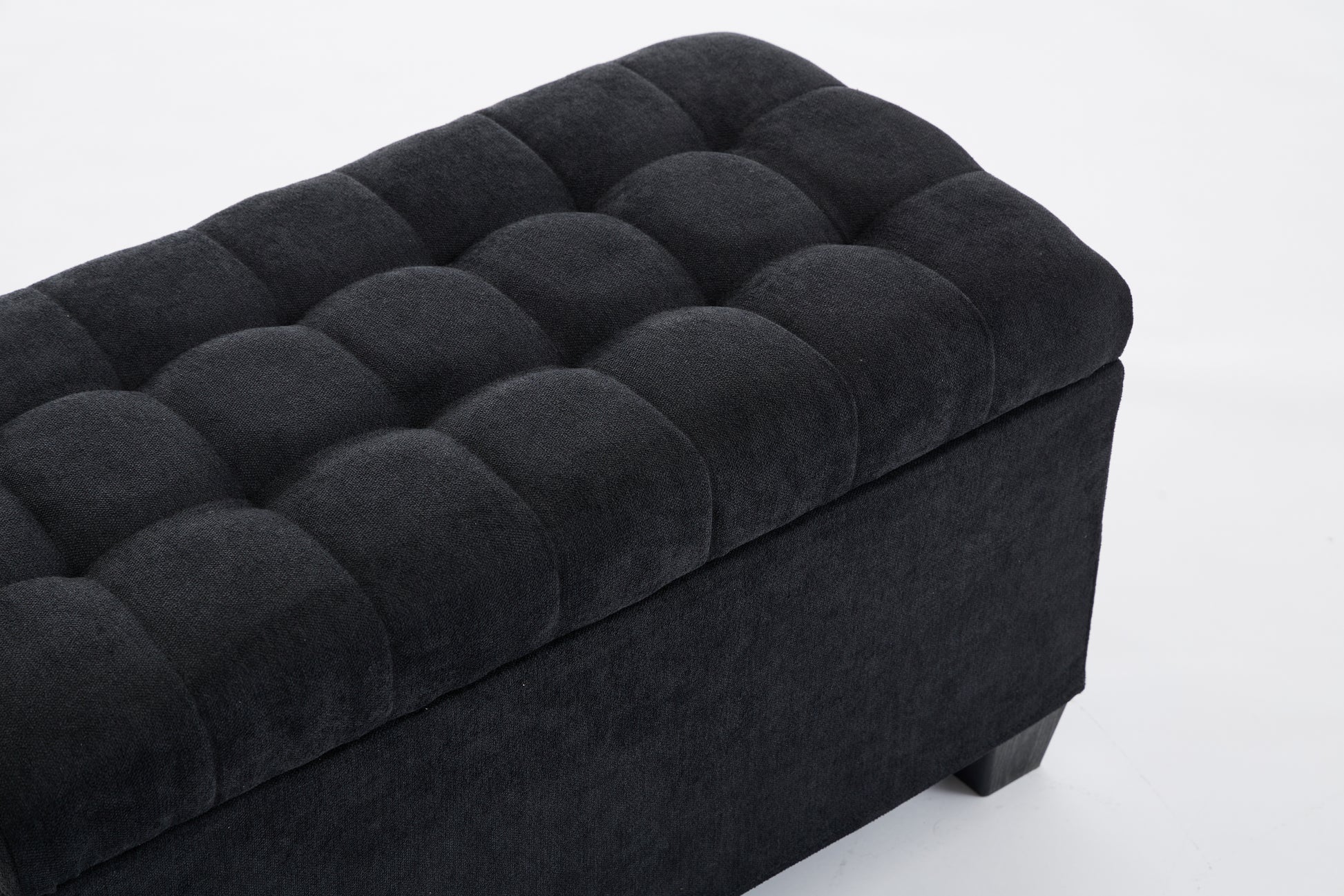 Black tufted storage ottoman with linenlike fabric