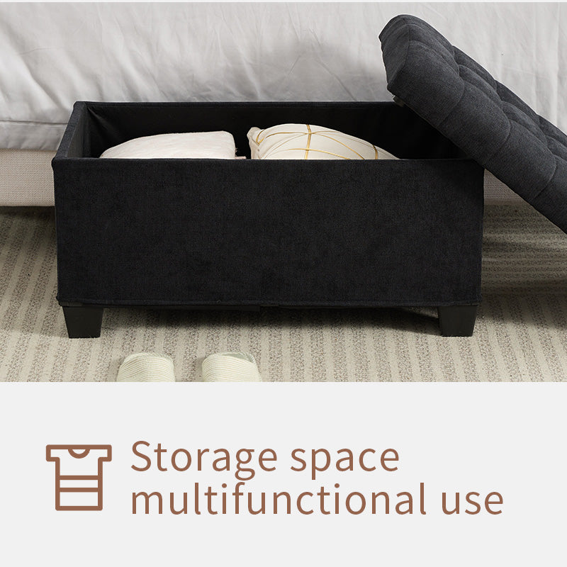 Black fabric storage ottoman with lifttop lid storing pillows and blankets