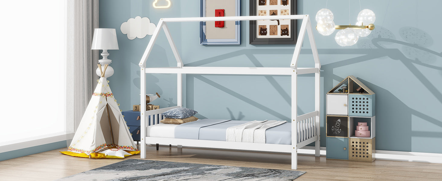 White wooden house bed frame with blue bedding and pillows