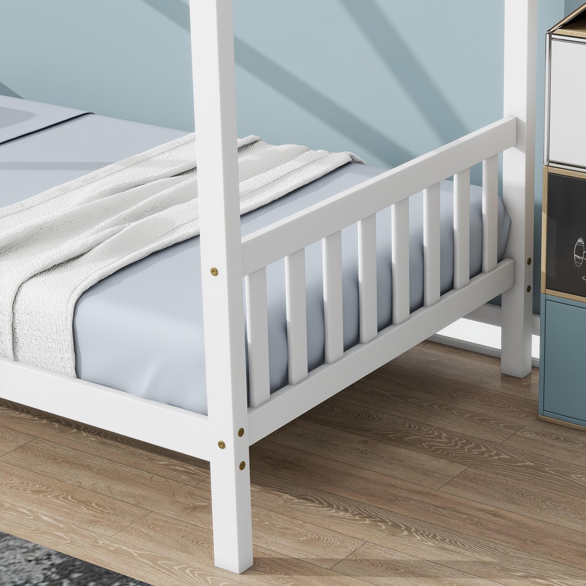 White wooden fourposter bed frame with a light blue mattress and textured blanket