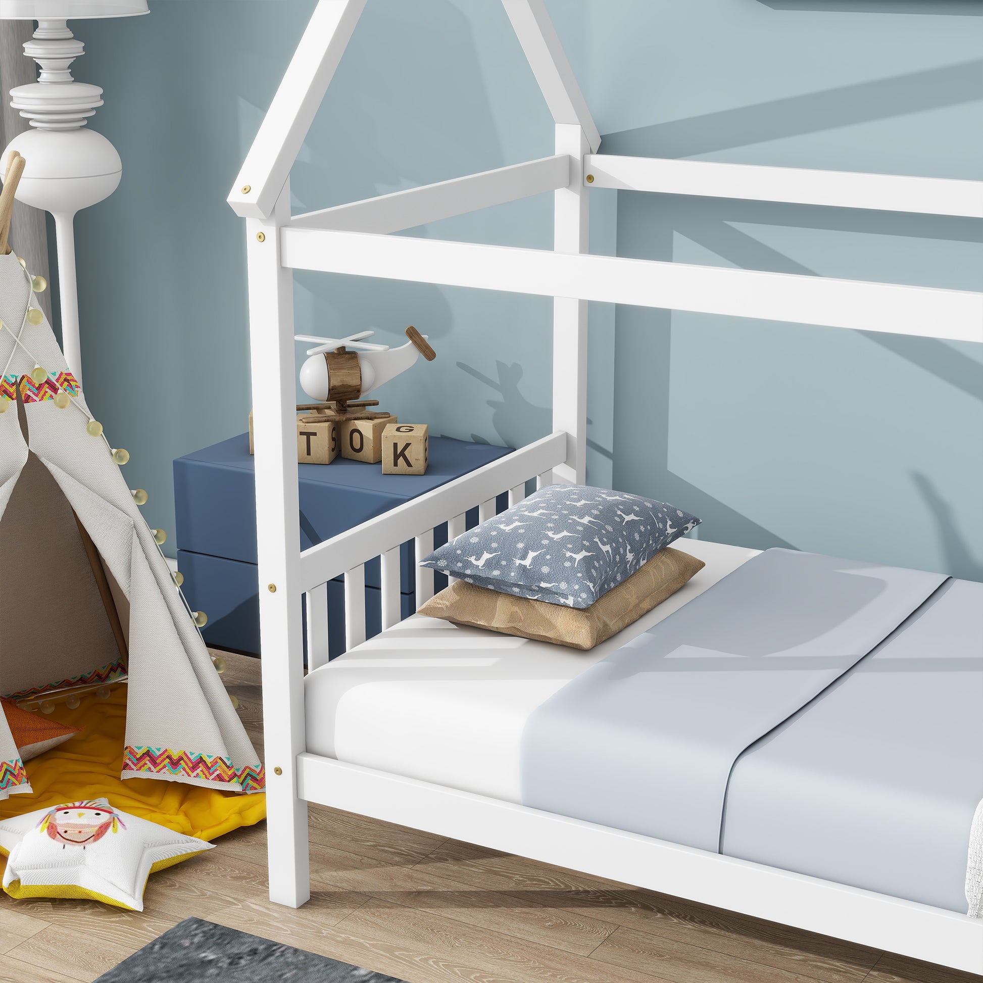 White wooden twin house bed frame with blue pillows and tan throw pillow