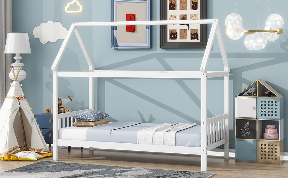 White wooden house bed frame with blue bedding and pillows