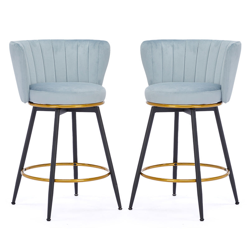 Light blue velvet bar stools with gold accent rings and black legs