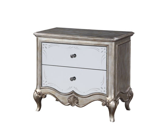 Antique silver nightstand with mirrored drawers and ornate carvings