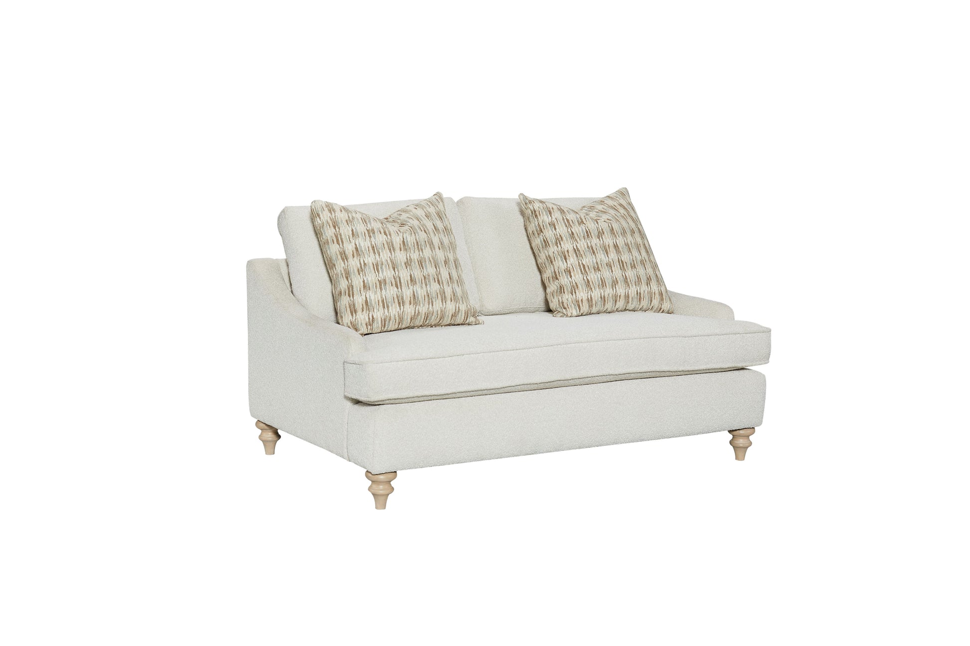 Cream textured loveseat with patterned throw pillows and wooden turned legs