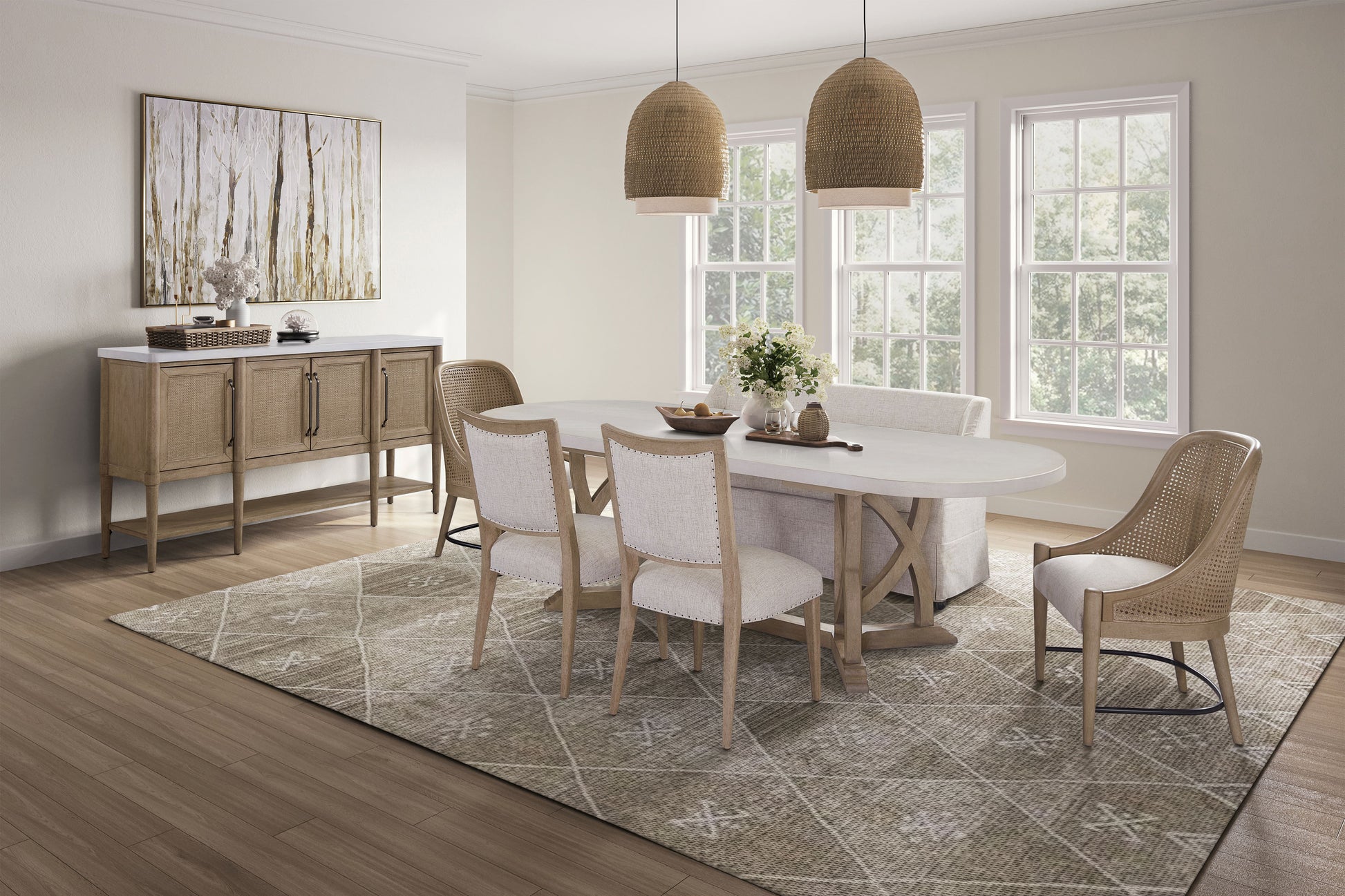 Oval dining table with woven chairs and natural wood sideboard