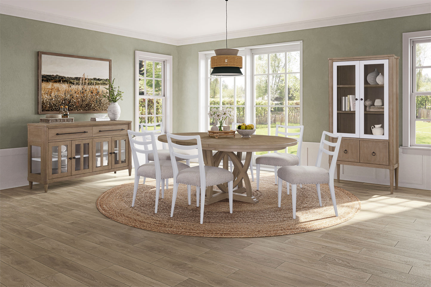 Rustic round dining table with four white chairs and natural fiber rug