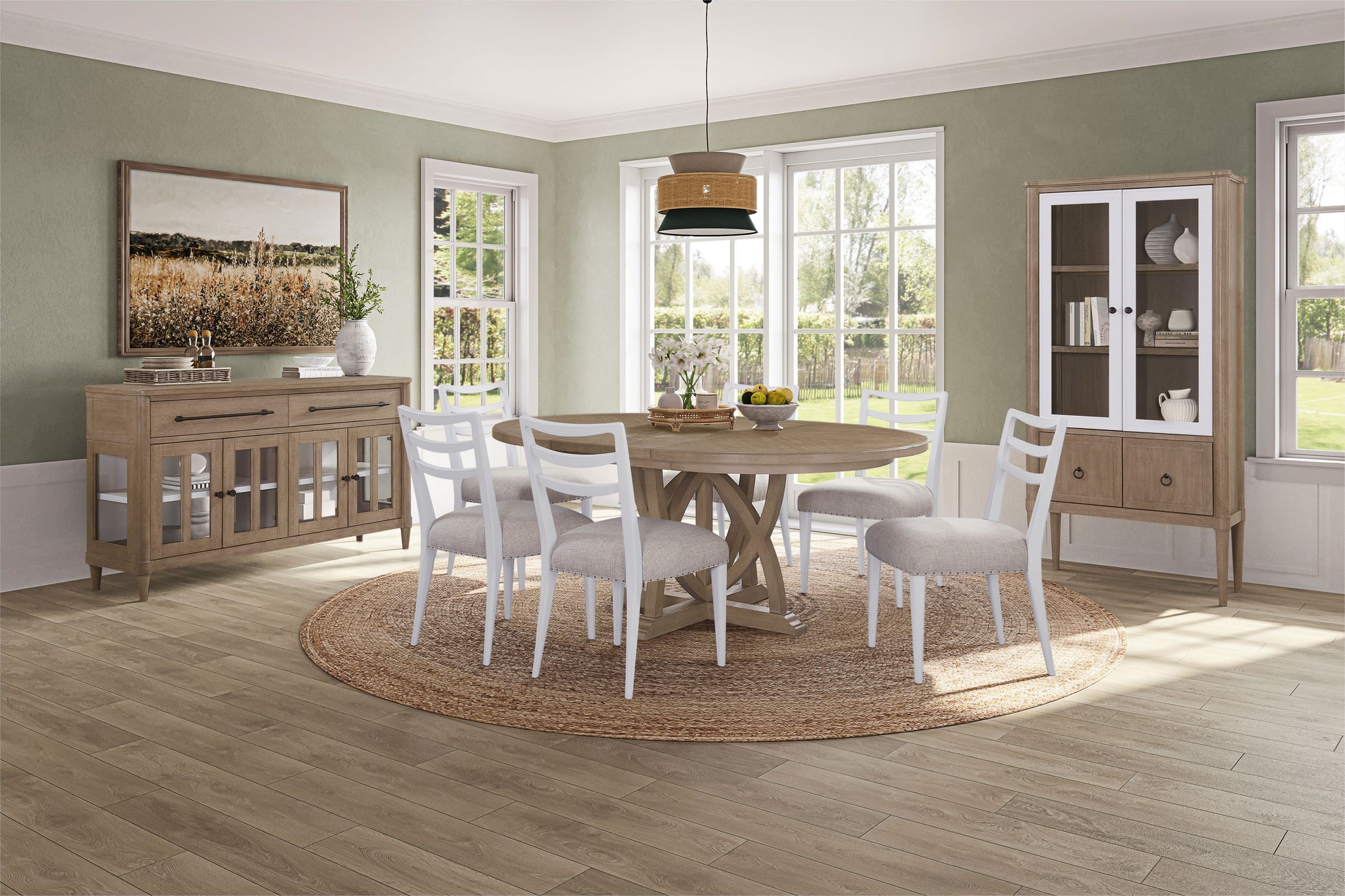 Rustic round dining table with four white chairs and natural fiber rug