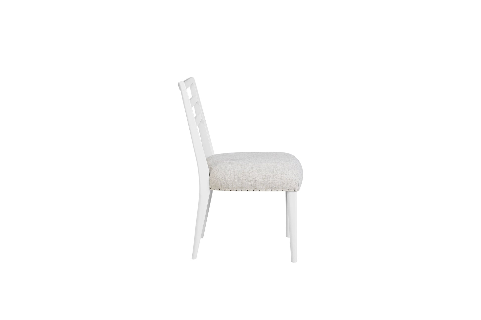 White upholstered dining chair with decorative nailhead trim and a unique open back design