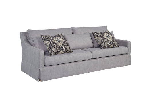 Textured gray fabric sofa with ornate patterned accent pillows for living room decor