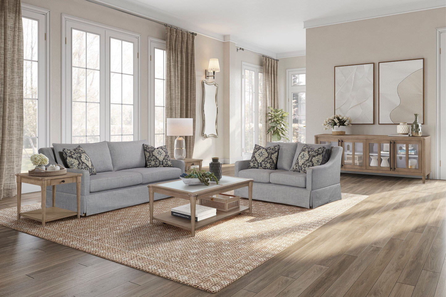 Gray upholstered sofa with decorative throw pillows and wooden end table