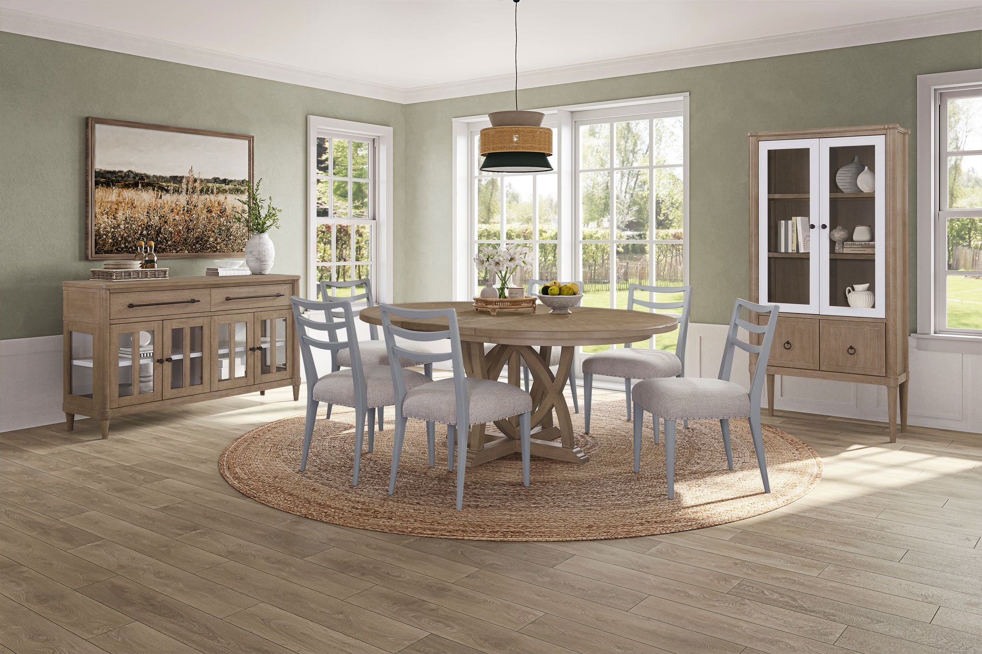 Round oak dining table with distressed wood pedestal base and six grey upholstered chairs