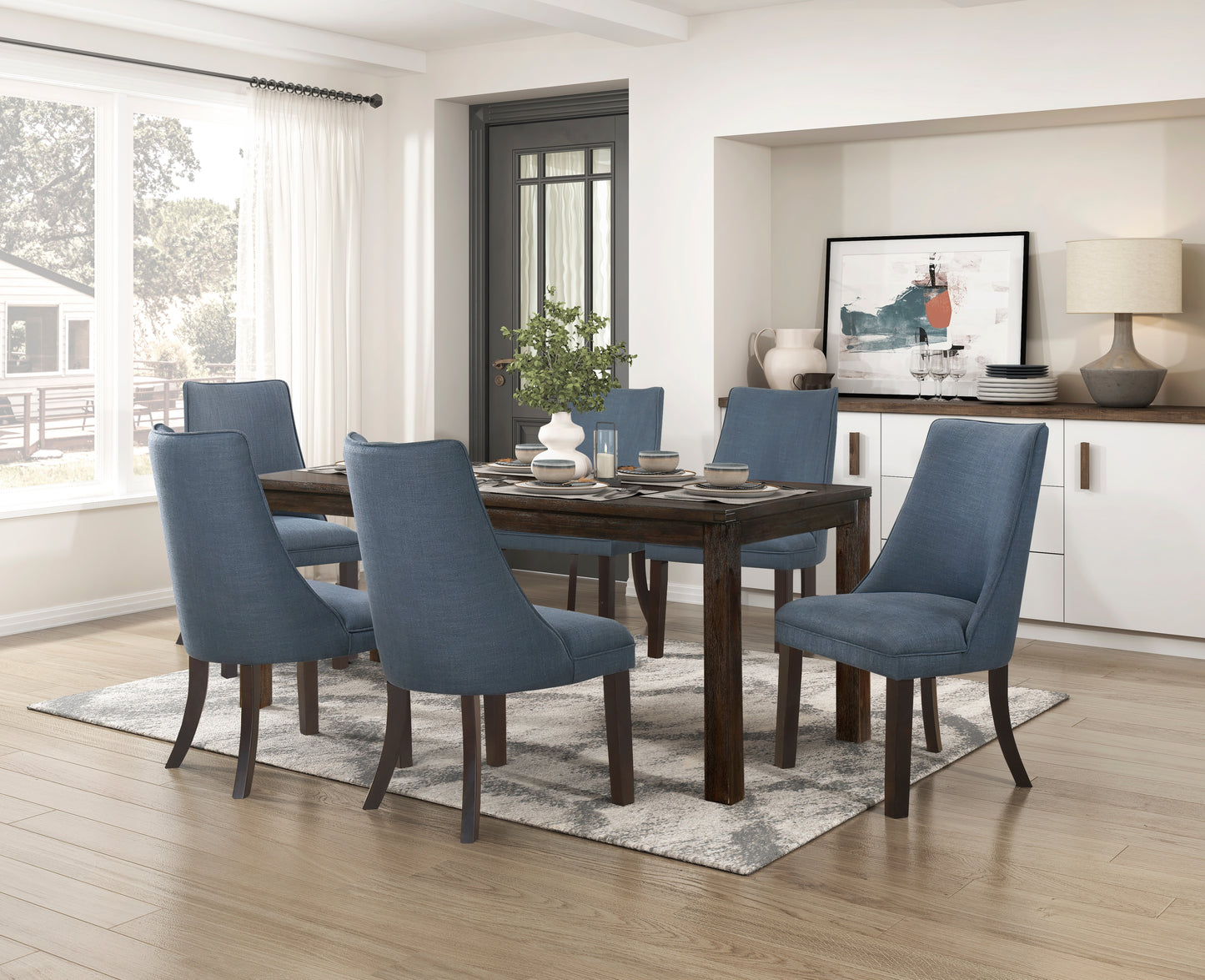 Blue upholstered dining chairs surrounding a dark wood dining table