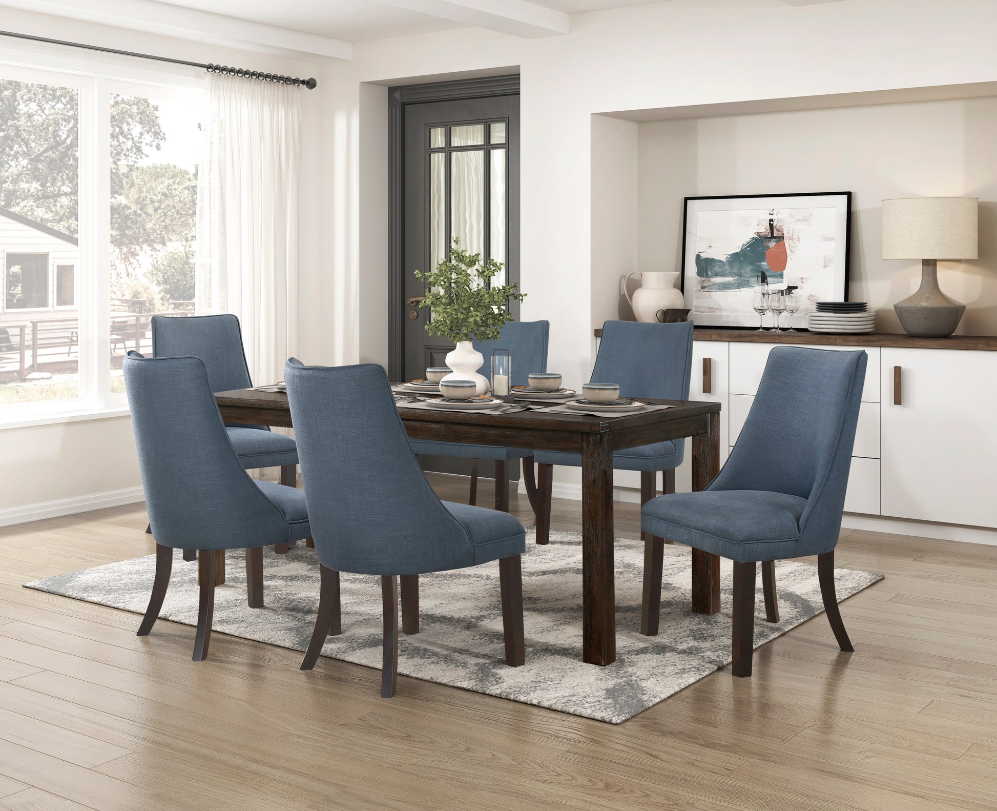 Blue upholstered dining chairs surrounding a dark wood dining table