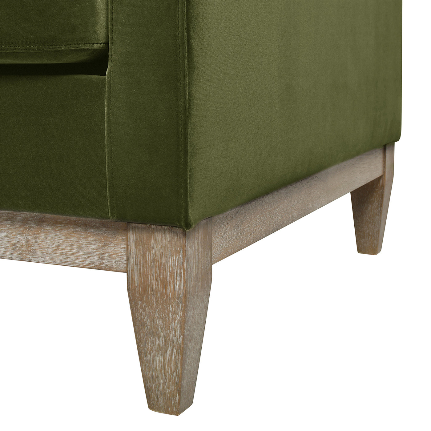 Moss green velvet sofa with light wood tapered legs