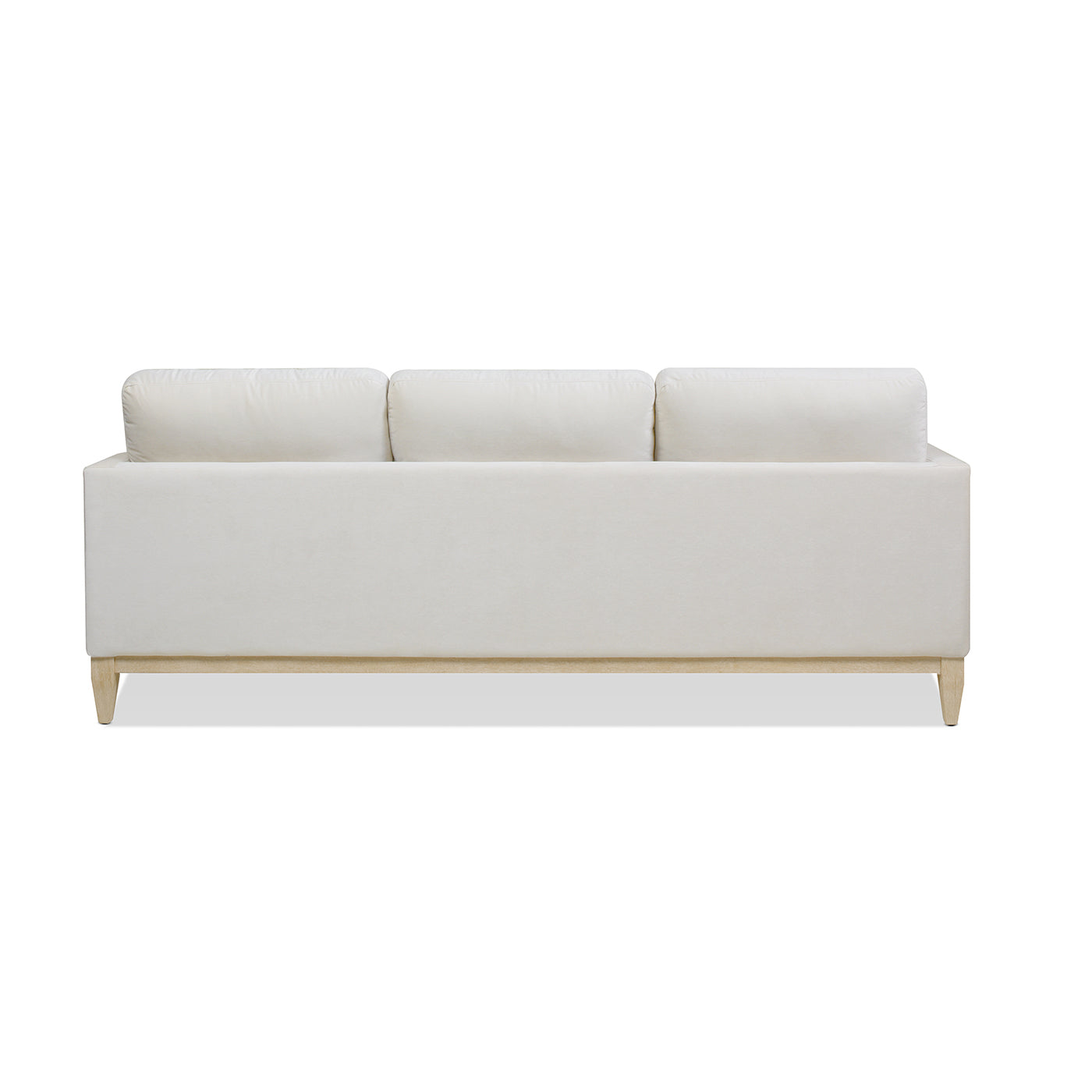 Modern cream velvet sofa with plush back cushions and light wood legs