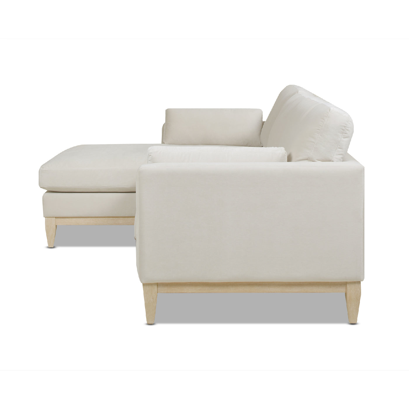 Cream sectional sofa with plush cushions and light wood legs