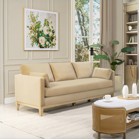 Cream velvet threeseater sofa with wooden legs