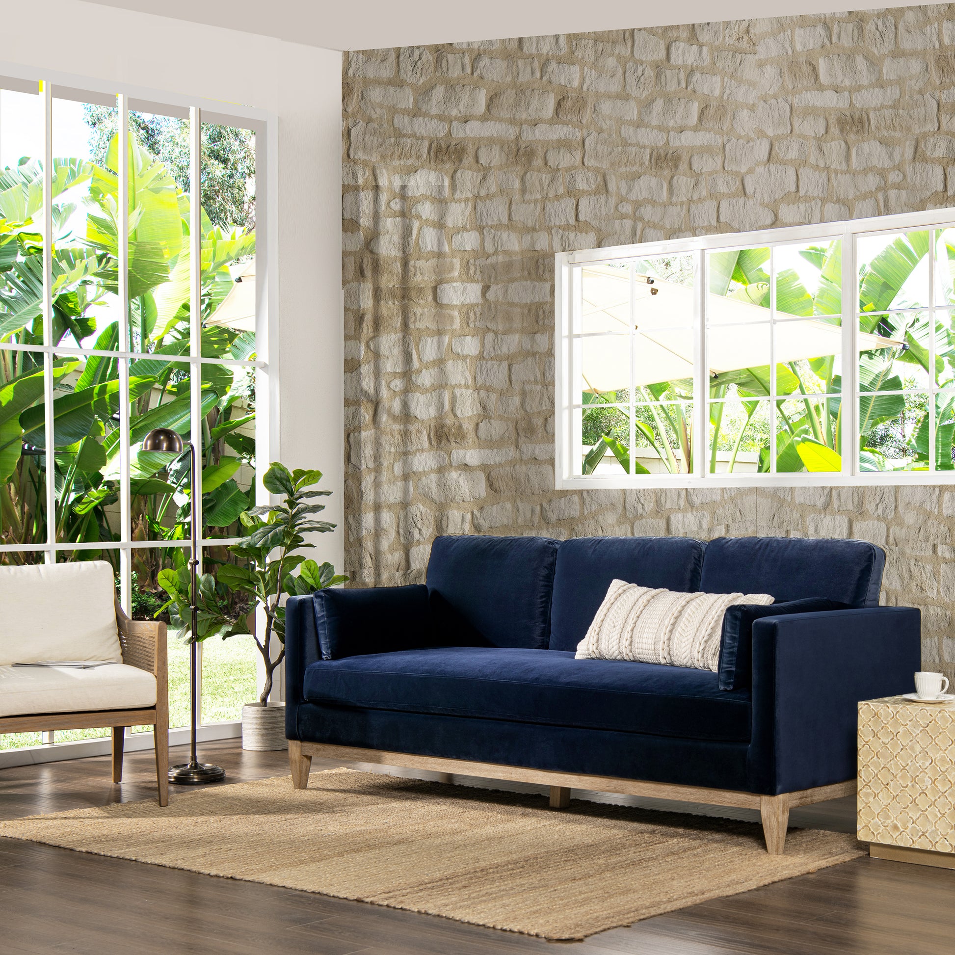 Navy velvet sofa with a textured white pillow
