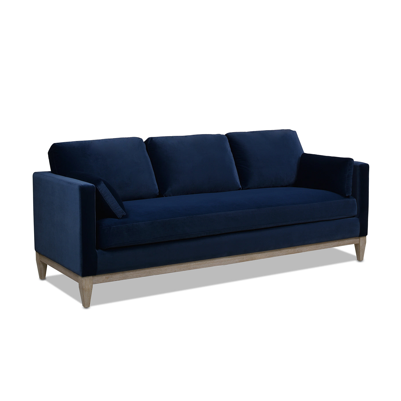 Deep navy velvet sofa with plush cushions and light oak wood legs