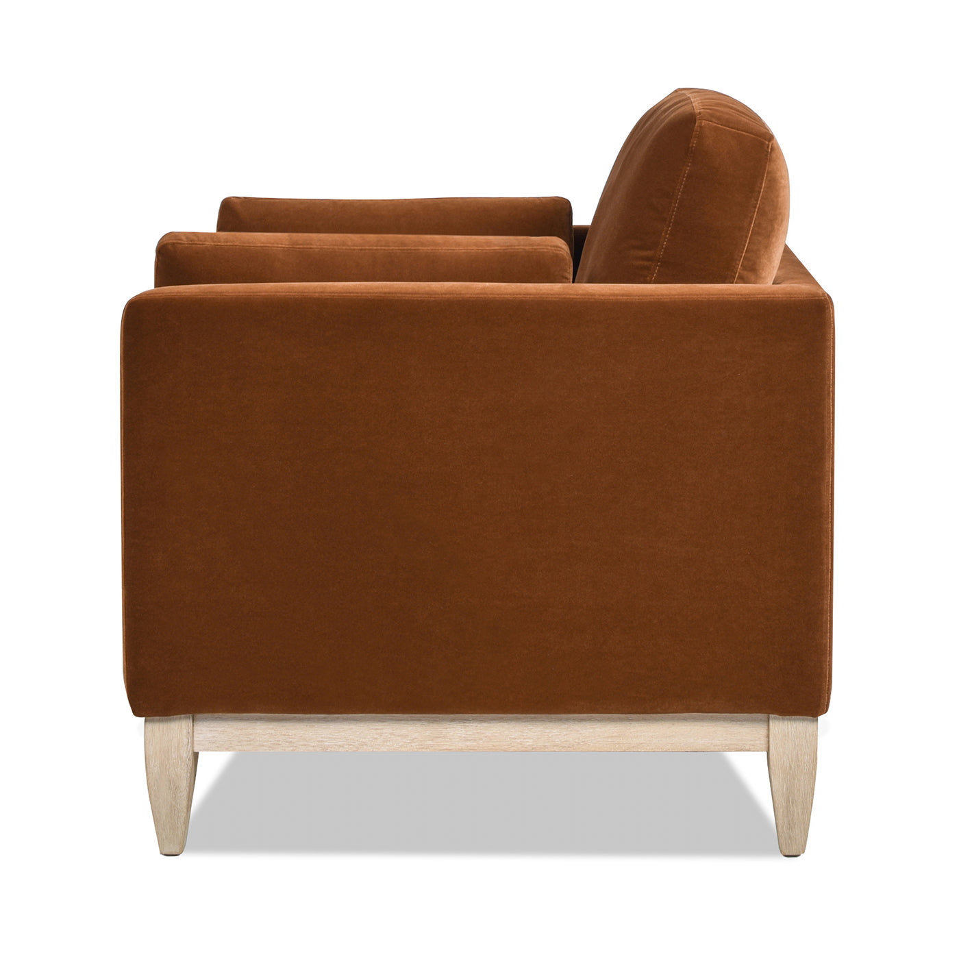 Brown velvet sofa side view with light wood legs