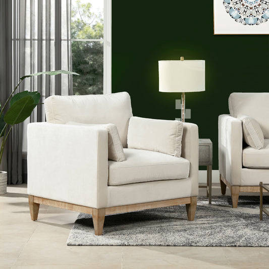 Cream velvet armchair with plush cushions and natural wood legs