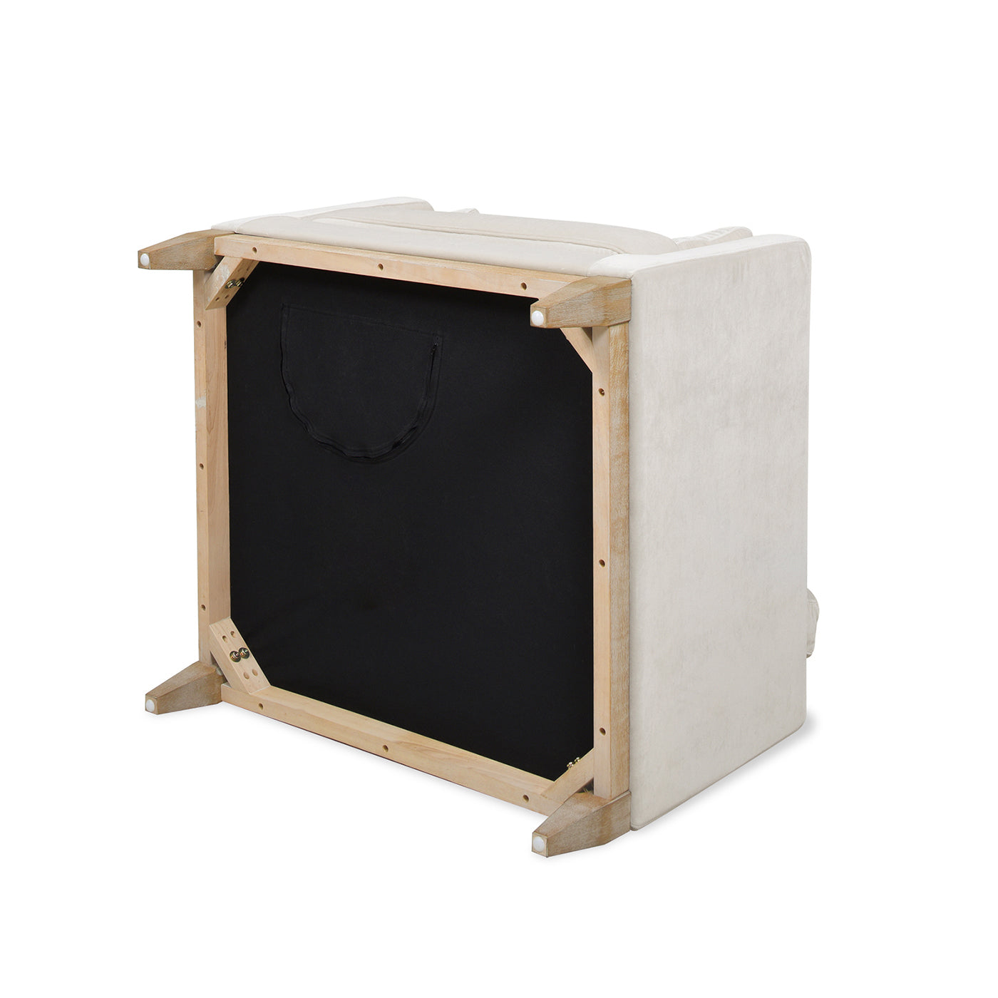 Upsidedown view of a cream velvet armchair showing its light wood frame and black fabric underskirt