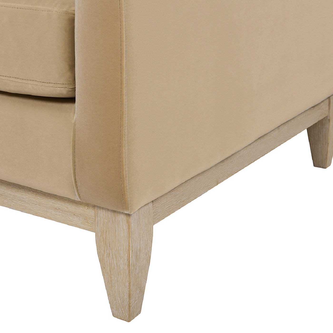 Beige fabric armchair detail with natural wood legs