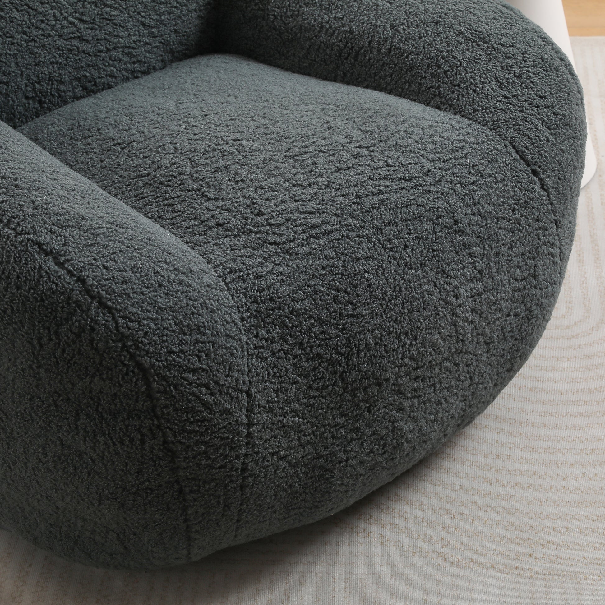 Plush dark grey teddy bear fabric armchair seat closeup