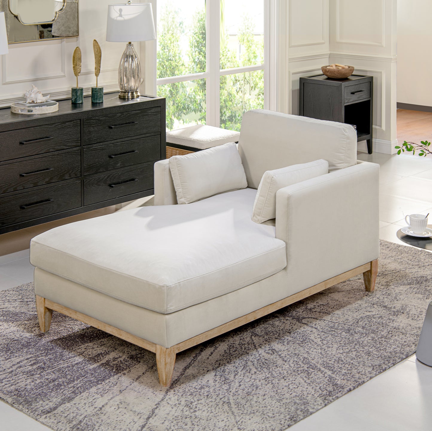 Cream velvet chaise lounge with wooden legs and lumbar pillows