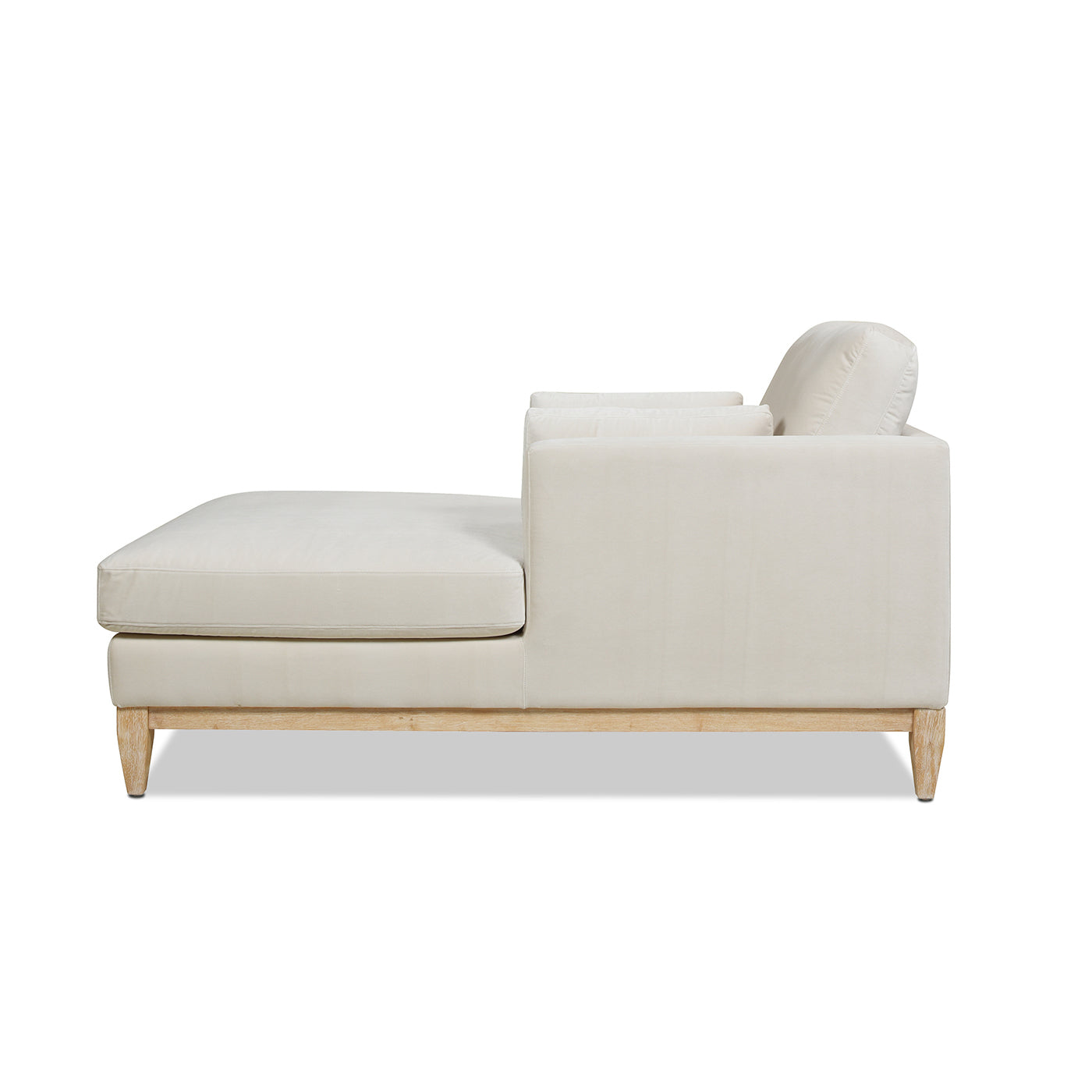 Elegant ivory velvet chaise lounge with light oak wood frame and modern design