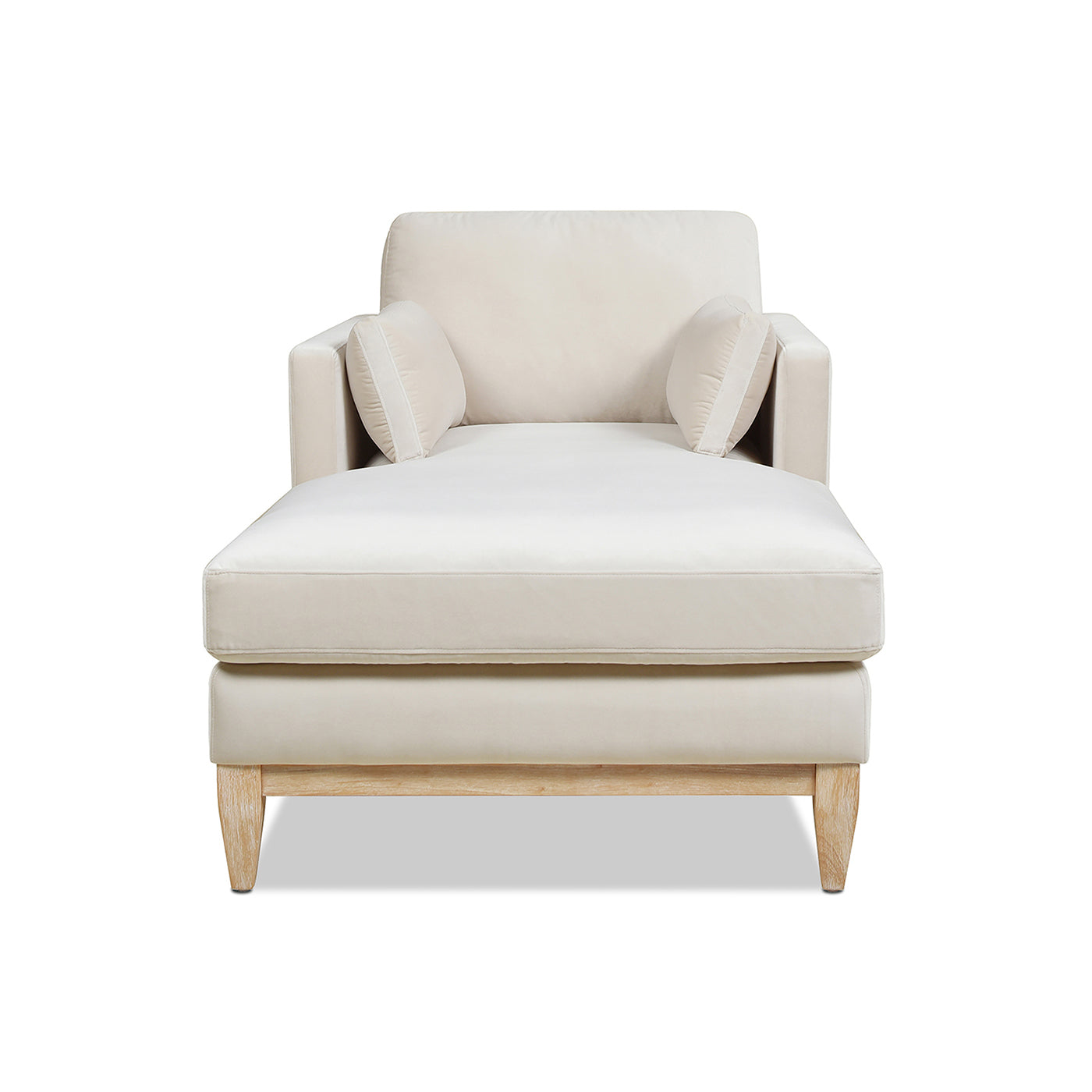 Cream chaise lounge with two throw pillows and light wood legs